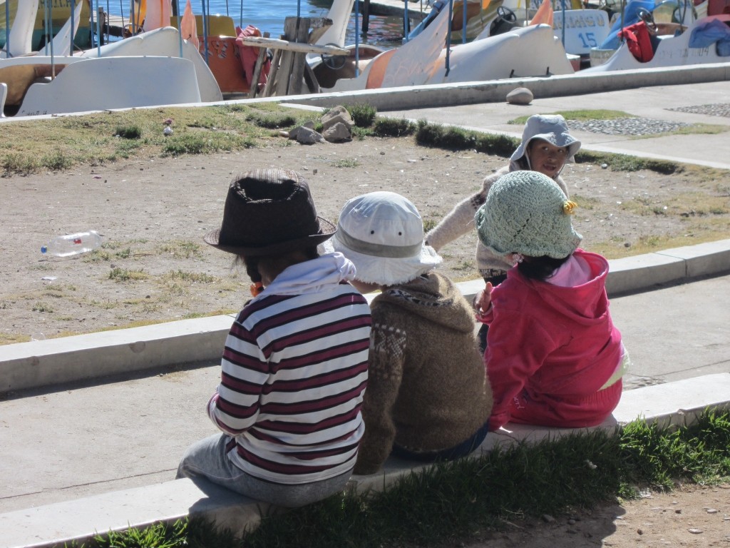 Children wearing their sunhats near Lake Titicaca