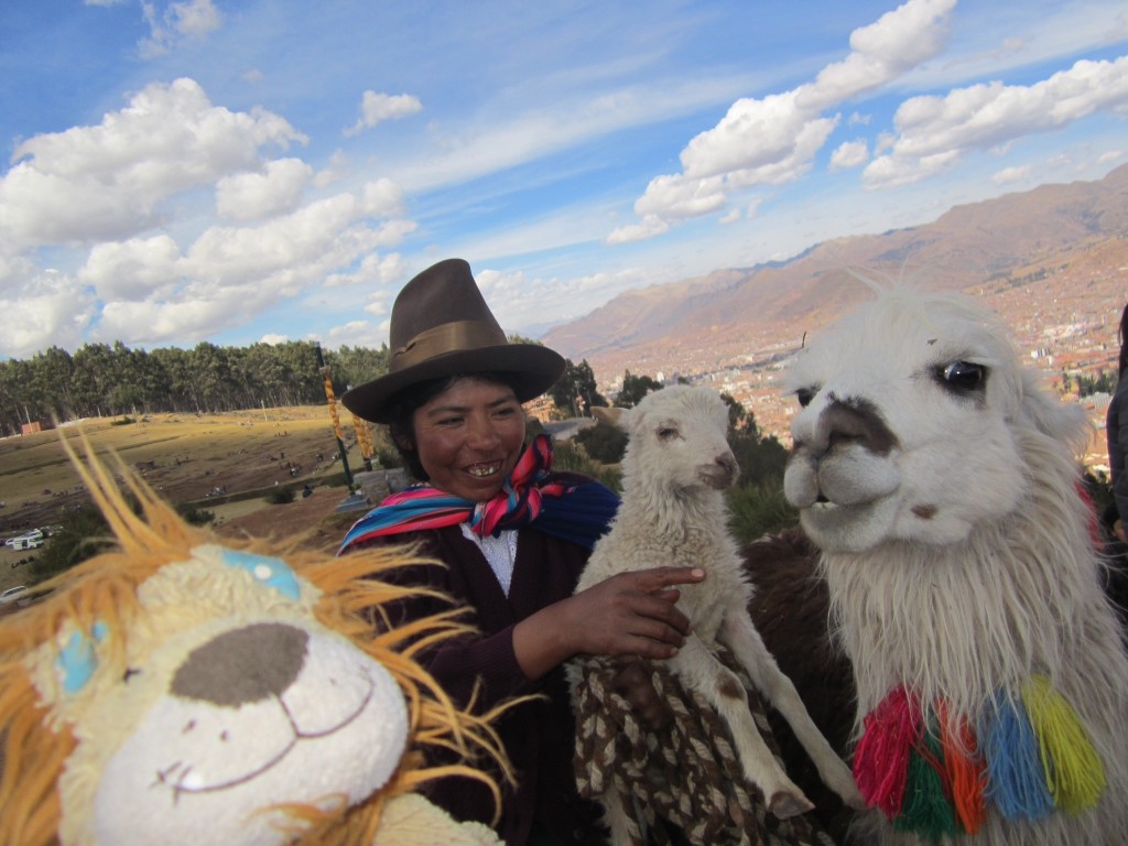 Lewis meets a llama, a sheep and a traditionally dressed Peruvian