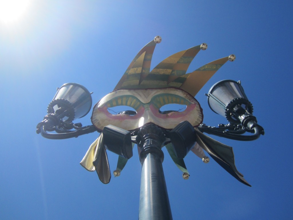 A typical Venetian mask on the lamp-posts