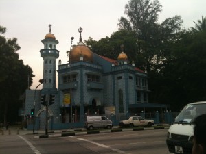 A mosque stands on the corner of the street
