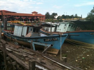 A boat lies by the riverside in Mersing