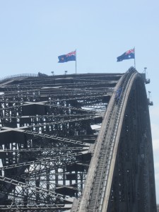 The Australian flags fly high whilst some people do the bridge climb 
