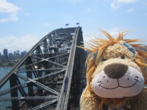 Lewis the Lion pretends that he's nearly the same height as the Sydney Harbour Bridge 