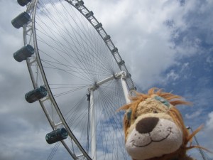 Lewis the Lion looks up at the huge Singapore Flyer