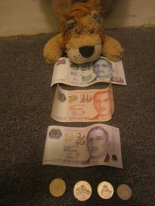 Lewis checks out some of the Singaporean currency