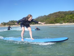 Helen wobbles a little bit as she stands up on her surfboard