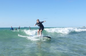 Helen rides the waves on her surfboard!
