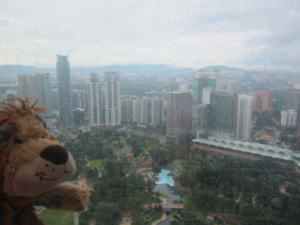 Lewis the Lion looks out onto a drizzly Kuala Lumpur