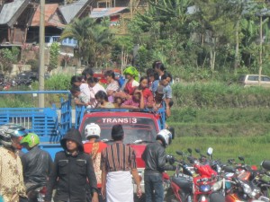 Many villagers arrive in flat-back vans