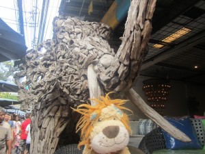Lewis the Lion poses by this wooden elephant in the Chatuchak market