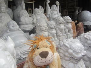 Lewis notices some traditional Thai marble statues, including some lions!