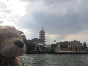 Lewis the Lion passes by ornate Thai temples and buildings