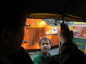 A child begs as the tuk-tuk stops