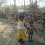 Children wash their pots in the street tap