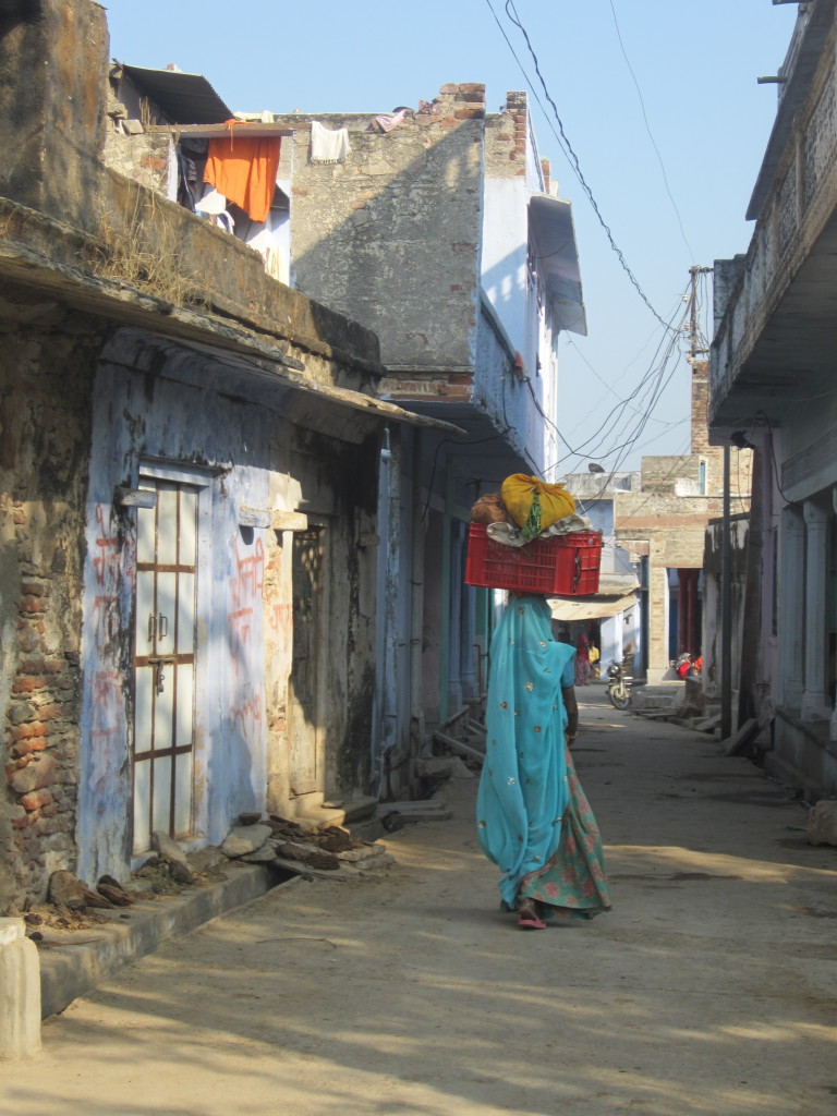 A villager carries a basket on her head