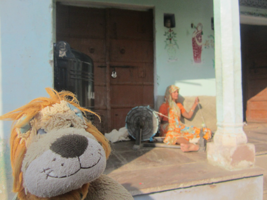 Lewis the Lion watches the woman at her spindle