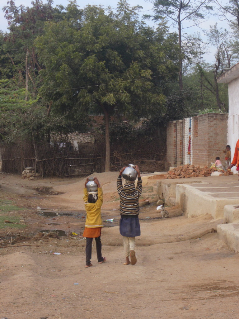 Children carry waterpots home