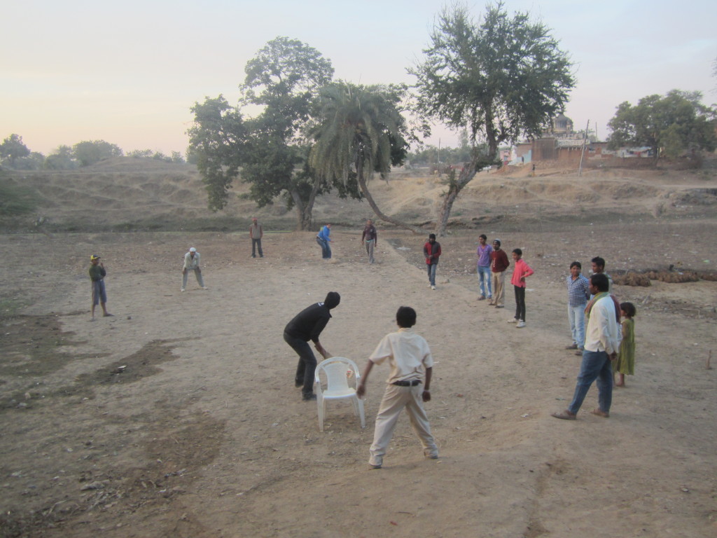 Dushyant and Seetal play a game of cricket with the locals