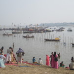 People arrive on boats by the water's edge
