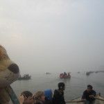 Lewis watches the rowing boats on the River Ganga